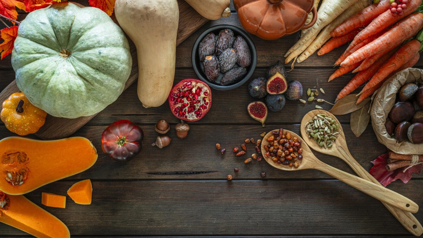 Autumn nutrition with pumpkins, pears, walnuts, sesame seeds and healthy seasonal foods