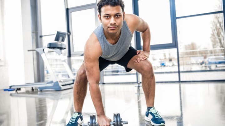 Young adult man performing strength training for long-term health and fitness